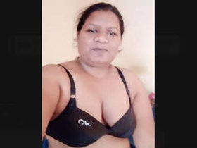 Indian housewife displays her large breasts
