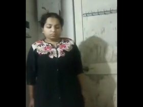 A lovely Indian homemaker showcases her figure in this recording