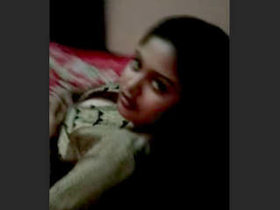 A very attractive Bengali woman moves sensually on the bed and displays herself