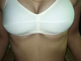 Indian woman flaunts her attractive physique while wearing a white bra
