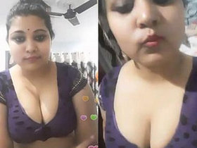 Voluptuous Indian woman with large breasts removes her saree and displays her stomach in a provocative manner