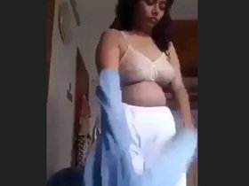 A young black woman records herself for her partner as she creates a video of affection