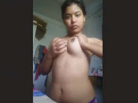A stunning woman flaunts her ample bosom in a captivating performance.