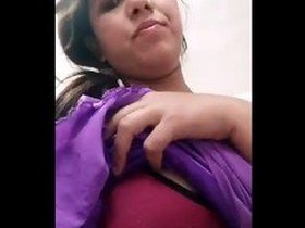 A lovely South Asian woman proudly displays her large breasts in this recording