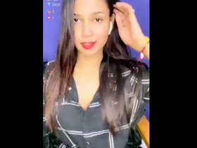 A pretty Indian girl displays her breasts during a real-time performance on Tango