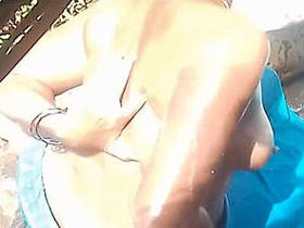 Indian aunt's clothed bath recorded on camera