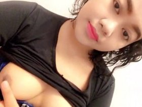 A young Desi girl reveals her alluring breasts in a solo performance