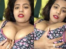 A girl from India with large natural breasts is squeezing them