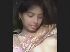 A young woman from a rural community displaying her breasts