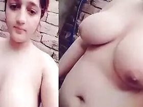 Rustic girl with huge tits poses in front of the bathroom